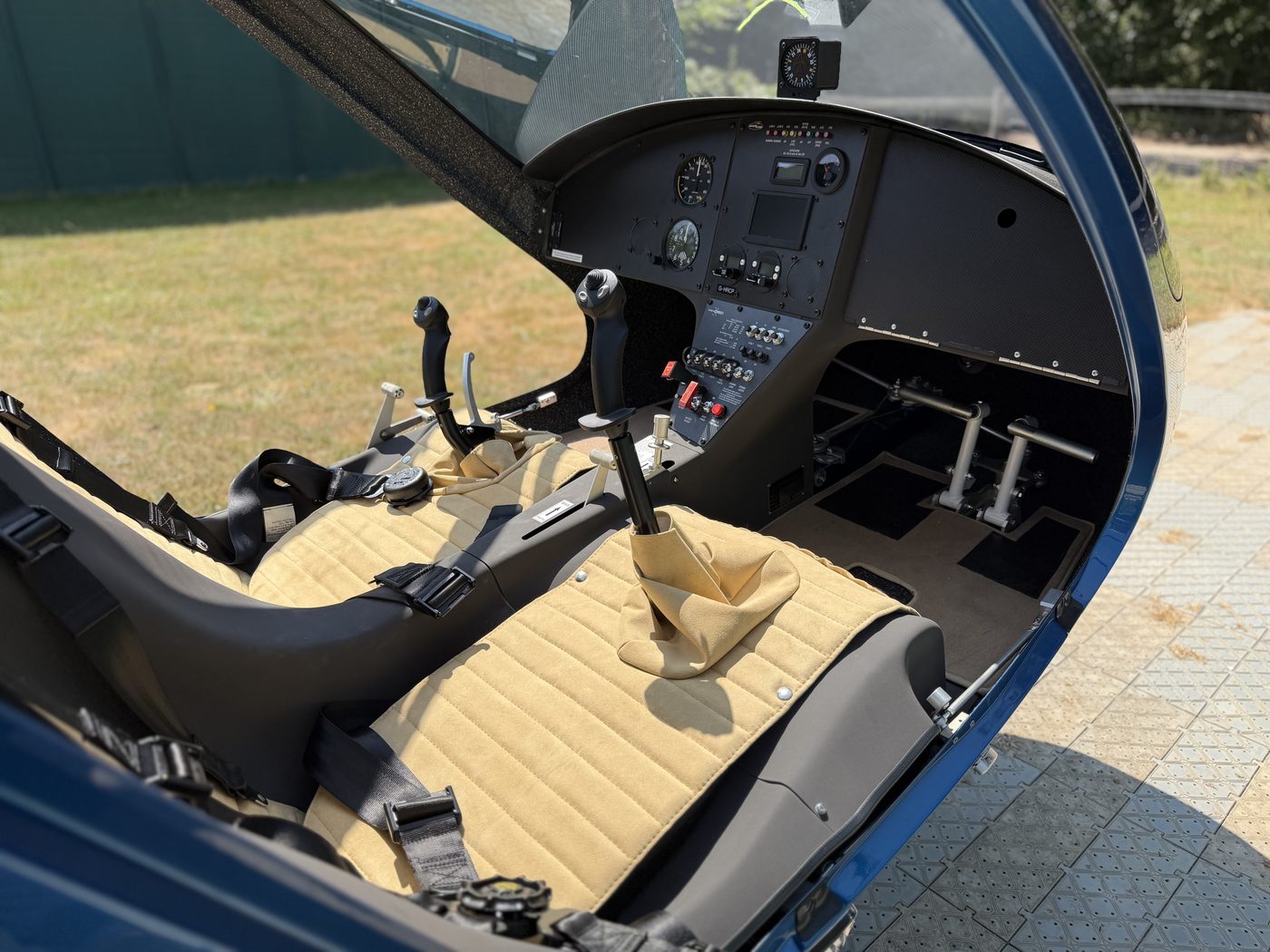 The two-seat cockpit of G-HRCP with sticks, pedals and instrument panel